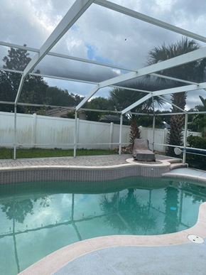 Sanford house for rent - a swimming pool with a large canopy over it