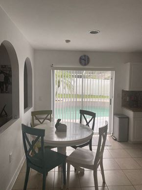 Sanford house for rent - a dining room with a table and chairs next to a pool