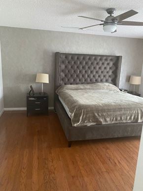 Sanford house for rent - a bedroom with a bed and a ceiling fan