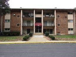 New Carrolton apartment for rent - A brick building with a red awning in front.