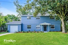 Jacksonville house for rent - a blue house with a lawn and a tree