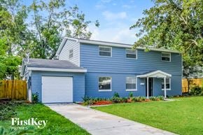 Jacksonville house for rent - a blue house with a white garage door