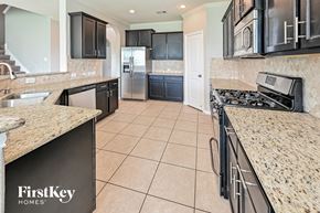 Baytown house for rent - a large kitchen with granite counter tops and stainless steel appliances