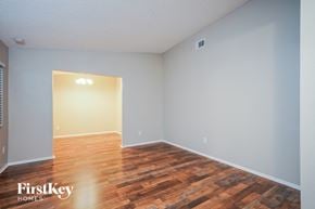 Orlando house for rent - A room with wooden flooring and a light on the wall.