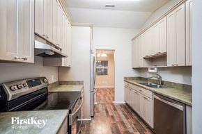 Orlando house for rent - A kitchen with wooden floors and white cabinets.