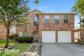 Fort Worth house for rent - A brick house with a tree in front of it.