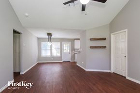 Conroe house for rent - an empty living room with wood flooring and a ceiling fan