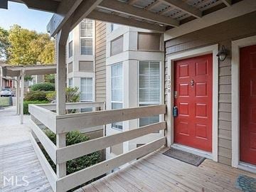 Marietta house for rent - A red door is on the right side of a wooden porch.