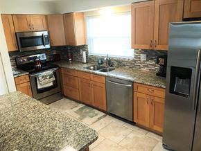 Palmetto house for rent - a kitchen with granite counter tops and stainless steel appliances