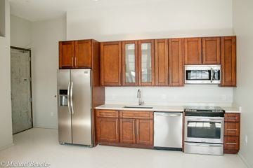 Charlestown apartment for rent - a kitchen with wooden cabinets and stainless steel appliances