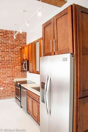 Charlestown apartment for rent - a kitchen with a stainless steel refrigerator and wooden cabinets