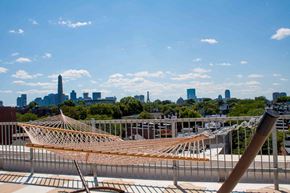 Charlestown apartment for rent - a hammock on the roof of a building with the city skyline in the background