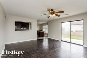 San Antonio house for rent - A spacious room with a ceiling fan and sliding glass doors.