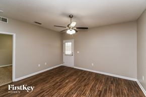 Jacksonville house for rent - the spacious living room with hardwood flooring and a ceiling fan