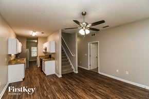 Jacksonville house for rent - an open kitchen and living room with a ceiling fan