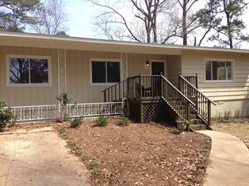 Jackson house for rent - A small house with a brown front yard.