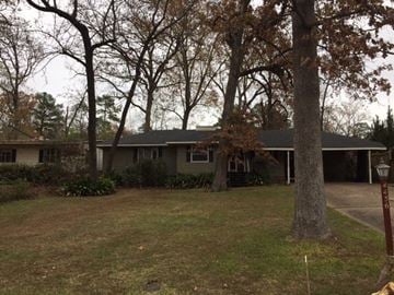 Jackson house for rent - A house with a grey roof and a tree in front.