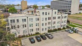 Jackson apartment for rent - a large white building with cars parked in front of it