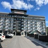 Belleville apartment for rent - A large building with a balcony on the top floor.