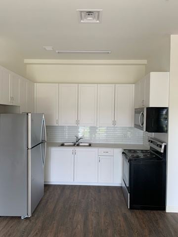Belleville apartment for rent - A kitchen with white cabinets and a black stove.