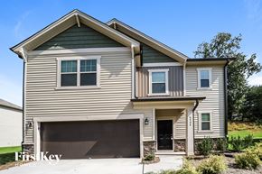 Winston Salem house for rent - A modern house with a garage is showcased in the image.