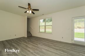 Winston Salem house for rent - A room with a ceiling fan and wooden flooring.