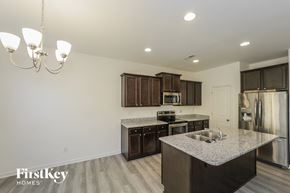 Winston Salem house for rent - A kitchen with a granite countertop and a chandelier.