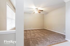 Indianapolis house for rent - A room with a carpeted floor and a ceiling fan.