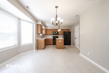 Indianapolis house for rent - A well-lit, spacious kitchen with a chandelier hanging from the ceiling.