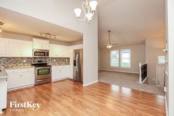 Kansas City house for rent - A kitchen with a stove top oven and a microwave.