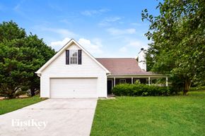 Covington house for rent - a white house with a white garage door and a lawn