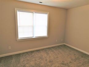 Jacksonville house for rent - A room with a window and carpeted floor.