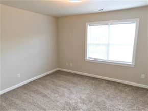 Jacksonville house for rent - A room with a carpeted floor and a window with blinds.