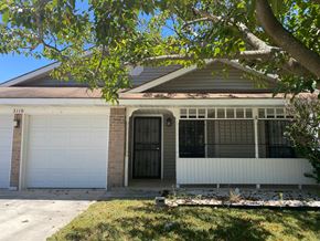 Killeen house for rent - A house with a white garage door and a brick pillar.