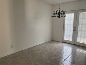 Killeen house for rent - A room with a tiled floor and a hanging light fixture.