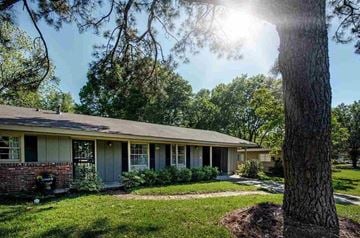 Jackson house for rent - A house with a tree in front of it.
