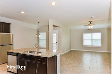 Converse house for rent - A kitchen with a sink and a refrigerator.