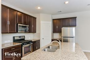 Converse house for rent - A kitchen with brown cabinets and a granite counter top.