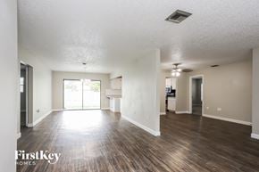 Largo house for rent - an empty living room with wood flooring and a kitchen