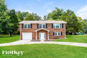 Clarksville house for rent - a brick house with a white door and a green lawn