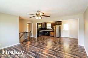 Clarksville house for rent - a kitchen and living room with hardwood floors and a ceiling fan