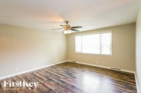 Clarksville house for rent - a bedroom with hardwood floors and a ceiling fan
