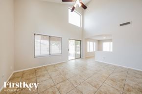 Peoria house for rent - A spacious room with a fan and tiled flooring.