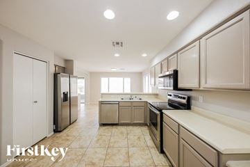 Peoria house for rent - A kitchen with beige cabinets and a tiled floor.
