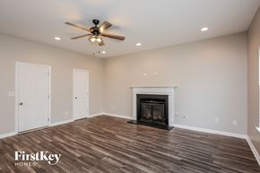 Pendergrass house for rent - a living room with a fireplace and a ceiling fan