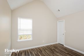 Pendergrass house for rent - a bedroom with wood floors and a window and a door
