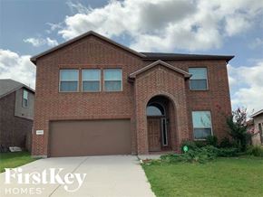 Weatherford house for rent - A brick house with a garage door and a window.