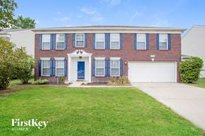 Fishers house for rent - A red brick house with a white door and blue shutters.