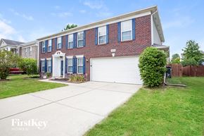 Fishers house for rent - A brick house with a white garage door and a white front door.