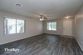 Queen Creek house for rent - the living room of an empty house with a ceiling fan